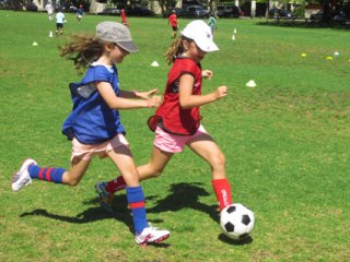 Children playing soccer, soccer camp, girls soccer